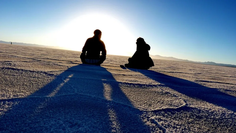 Couple sit a Chile Sand