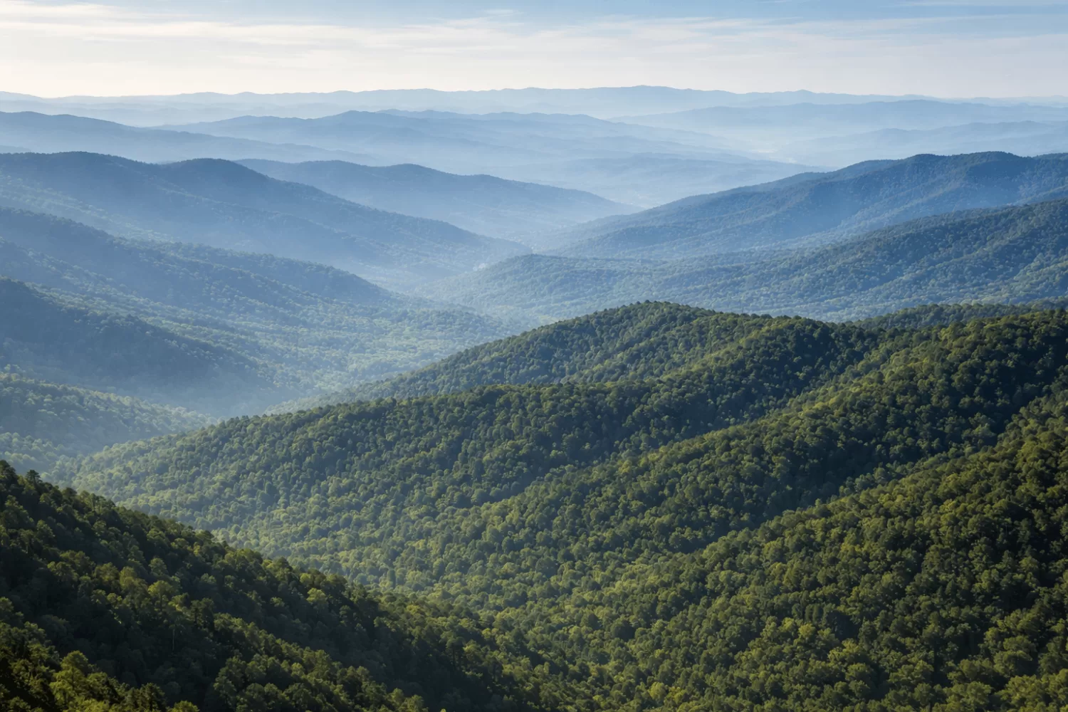 Wide aerial view of Appalachian mountain layers with blue haze and dense forest in Great Smoky Mountains